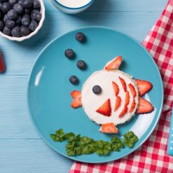 toast in a shape of fish sandwich with fruit elements
